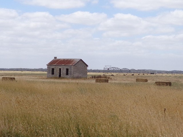 An abandoned house and an irrigator.