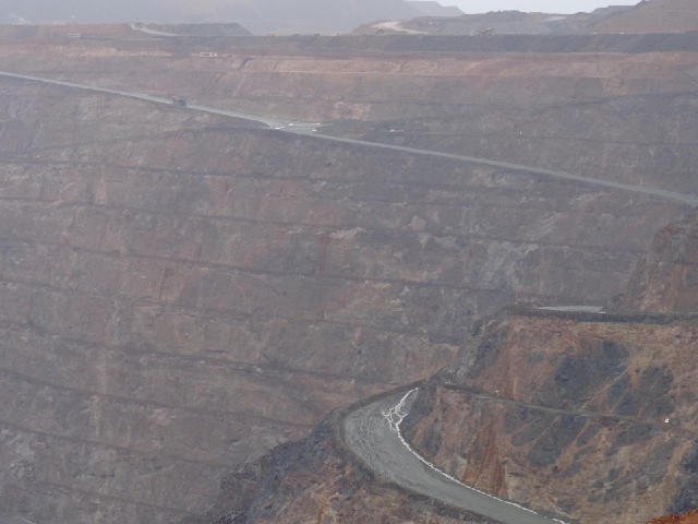 Some of the trucks which carry the rock are visible at the top of this picture. Each one holds 225 t...