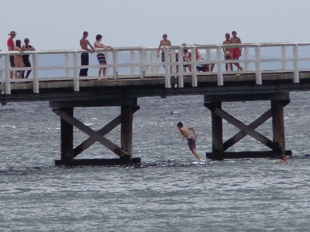 People jumping off the pier.