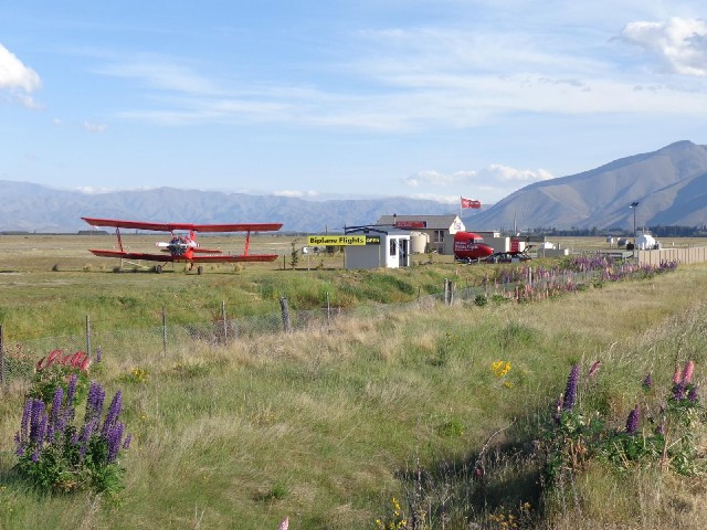 This place was offering biplane flights over Mount Cook. The flag said that you could fly now and th...