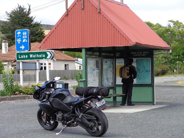 A motorcyclist looking at the map.