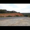 Exposed soil where the road has been cut through the hill.