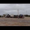 A road train with all sorts of stuff on it.