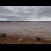 Part of Lake Cowan, which looks like just damp mud. The road and railway each run across it on raise...