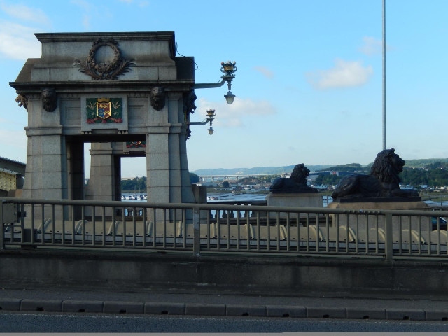 Ornamentation on the old road bridge, with the modern bridges in the background.