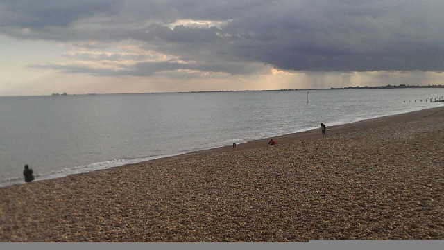 The beach at Hythe. Dungeness nuclear power station is on the horizon on the left. All the land on t...