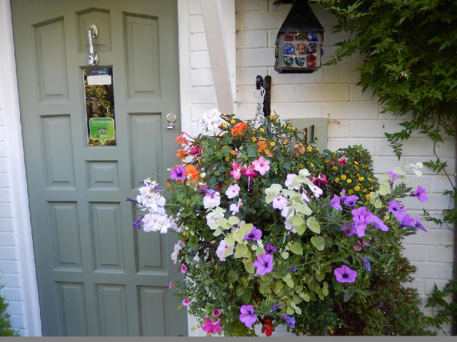 The house number and the doorbell are also quite hard to see, behind those flowers.