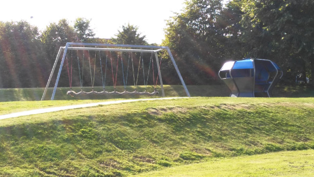 An interesting-looking swing in a play area.