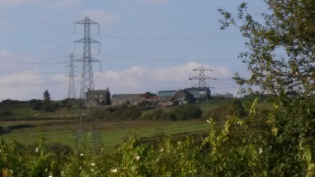 Just a farm on the hillside and some pylons.