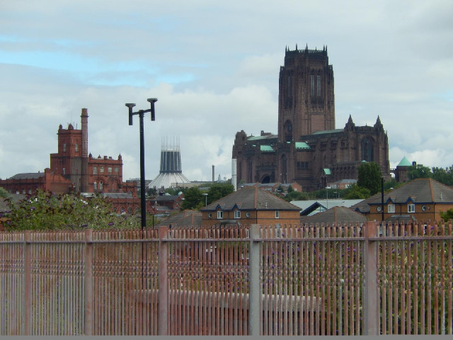 I think the building on the left is a brewery. The other two are Liverpool's cathedrals, both constr...