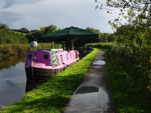 There are a lot of houseboats along this section of the Grand Union Canal. This one has a huge paras...