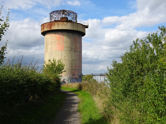 It's at the top of a hill next to the railway line. Possibly an old water tower.