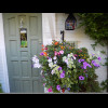The house number and the doorbell are also quite hard to see, behind those flowers.