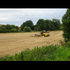 Just a combine harvester in a field.
