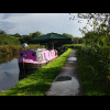 There are a lot of houseboats along this section of the Grand Union Canal. This one has a huge paras...