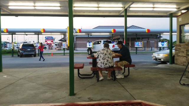 A drive-in restaurant. Not a drive-through but a drive-in, like in ...