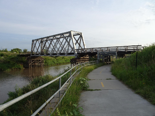 A railway bridge with wooden supports.