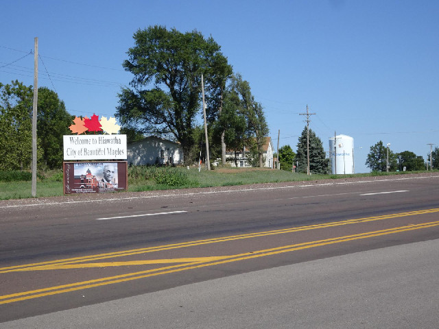 The sign calls Hiawatha "City of Beautiful Maples" and then boasts that it was the birthpl...