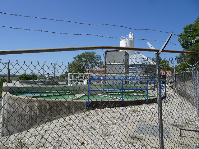 A water treatment facility. The water is very green.