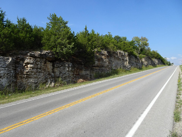 The rock has been cut away to allow the road to have a smooth gradient.