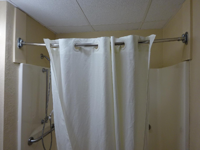 I've got another complaint about this bathroom. The shower curtain rail droops so the curtain slowly...