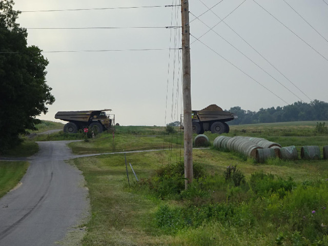 A full truck heading towards the ridge and an empty one heading away.