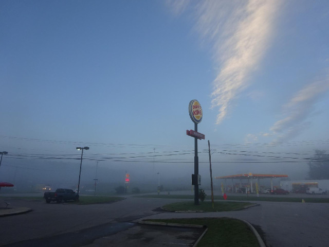 It's a foggy morning but the fog can't be very deep because I can see blue sky above it.