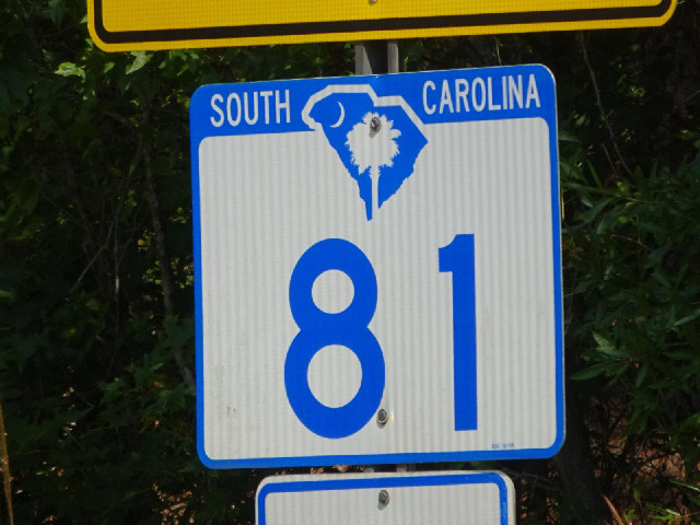 The road signs in South Carolina combine the shape of the state with the symbol off the flag.