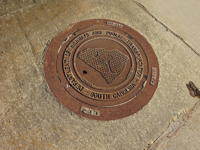 The state outline and logo on a manhole cover.
