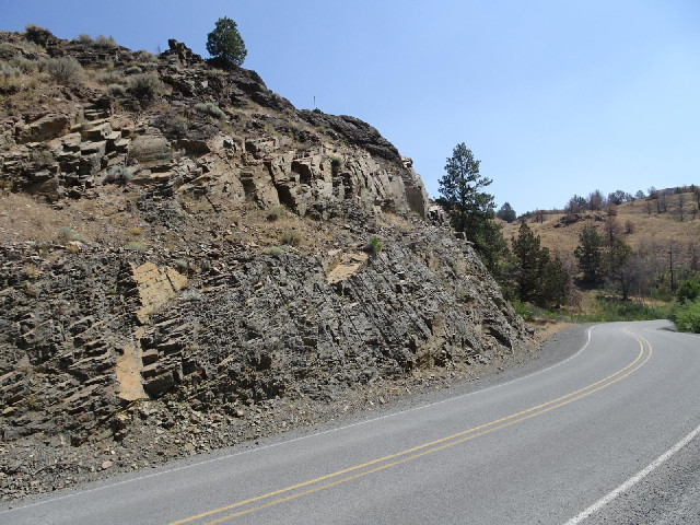 You can see where explosives were drilled into the rock to blast part of it away.