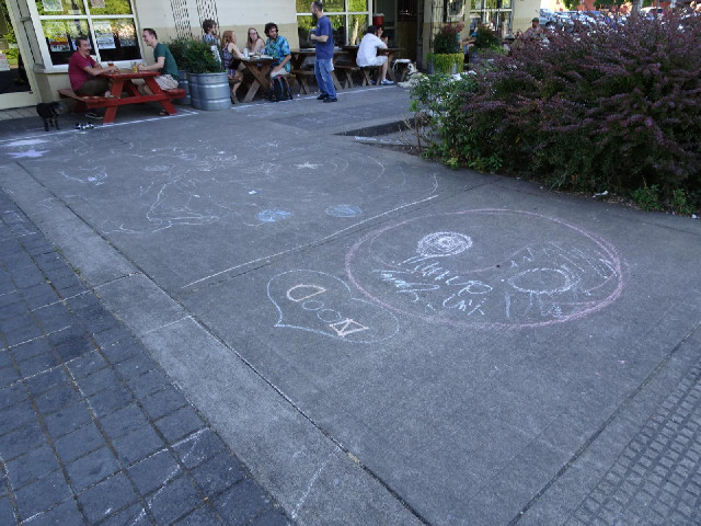 For a couple of streets, next to the river, the pavements are covered in chalk writing. I rode over ...