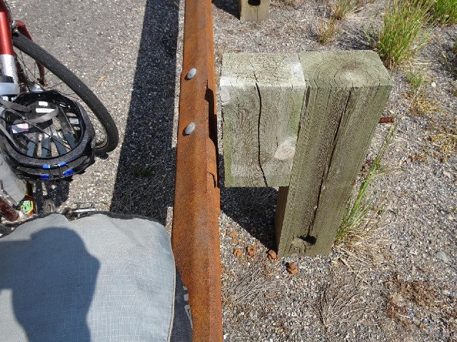 I leaned my bike against the barrier but then saw that it's not attached to the wooden support. The ...