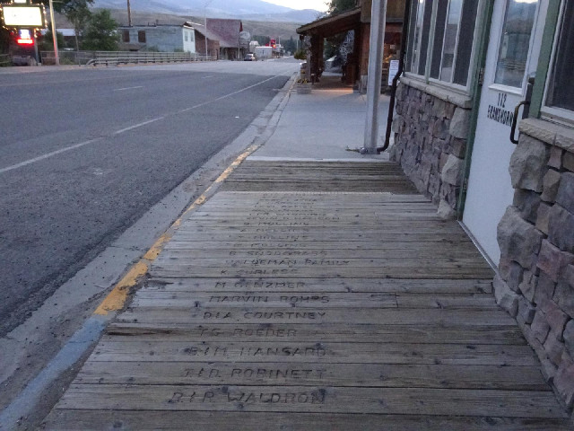 Names carved into the wooden sidewalk.