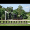 The pictures represent some early settlers. The concrete balustrade on the ground in front of them c...