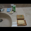 The round packet of soap is labelled "FACIAL BAR". The rear cardboard box is labelled &quo...