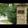 The cemetery's signs say "OPEN DAILY FROM SUNRISE TO SUNSET" and "NO TRESPASSING FROM...