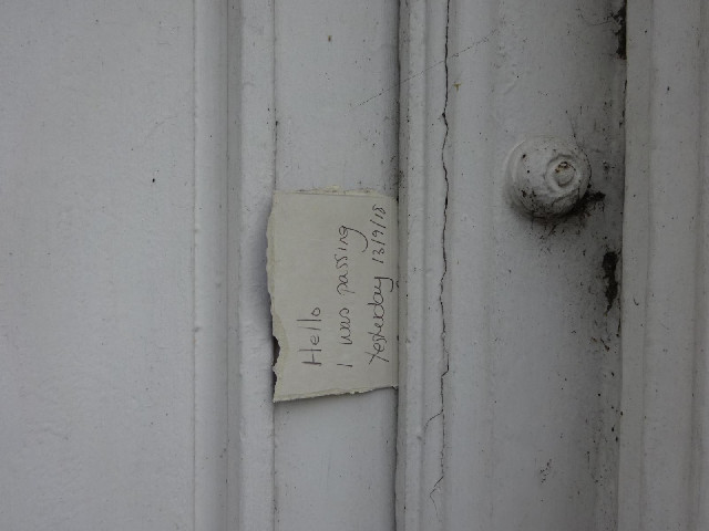 A note wedged into a doorframe.