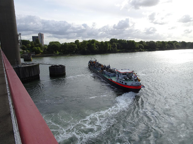 This boat is turning surprisingly close to the bridge supports.