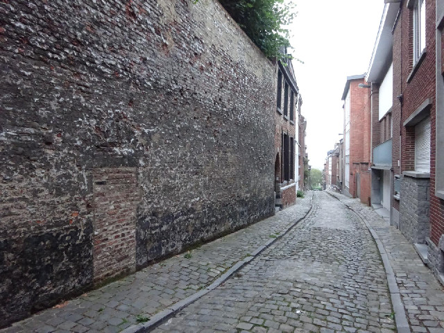 An old bricked-up doorway in another alleyway.