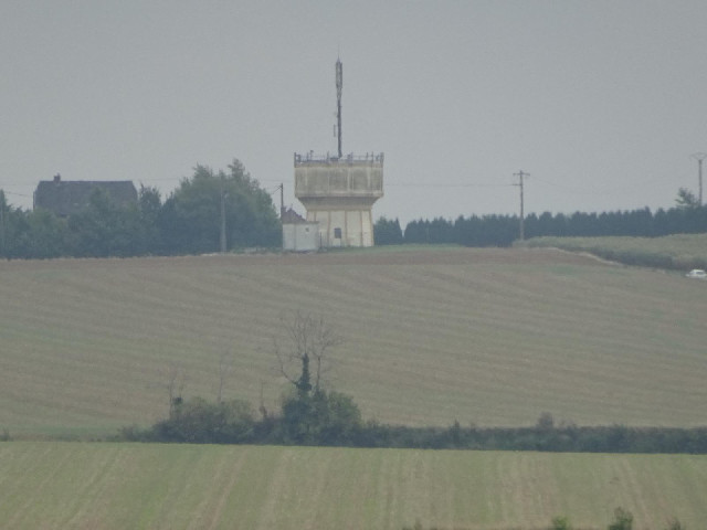 A water tower with a mast.