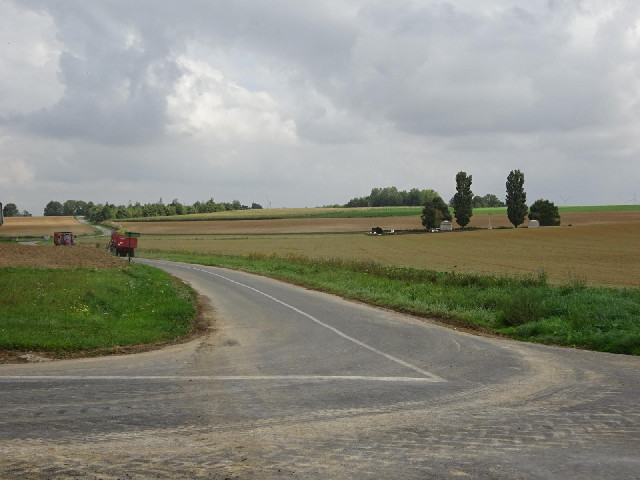 On the right, another cemetery. On the left, two of the remarkable number of tractors which are tran...