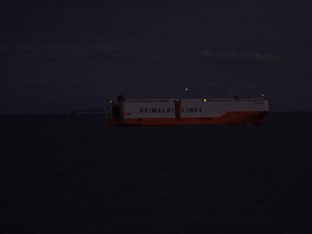 The transporter, with another ship just visible emerging from behind it.