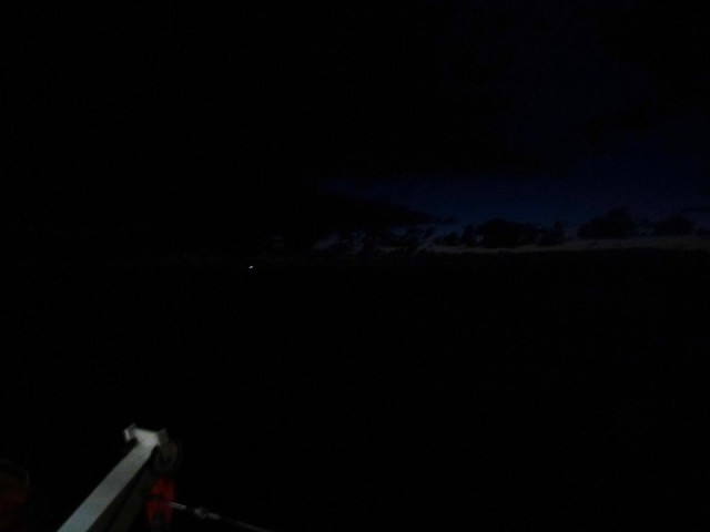 Dawn beginning to break in the East. I think the light is probably another boat. It's too far in fro...