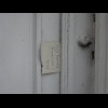 A note wedged into a doorframe.