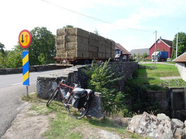 Two lorries which happen to have arrived at the same narrow bridge at the same time.