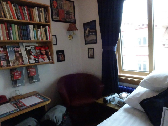 My room is tiny and hot but has a selection of books. There are more bookshelves throughout the hote...