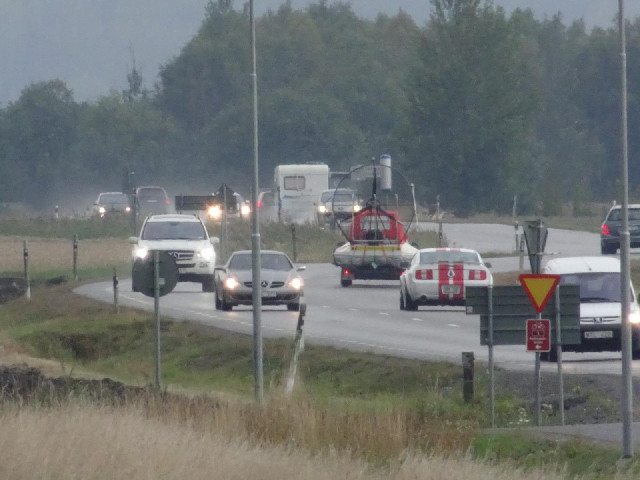 One of those vehicles is transporting a hovercraft.