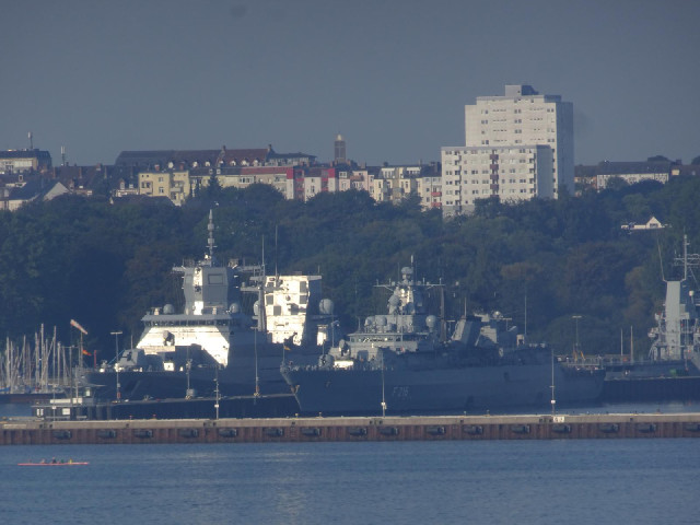 A warship glinting in the sunlight.