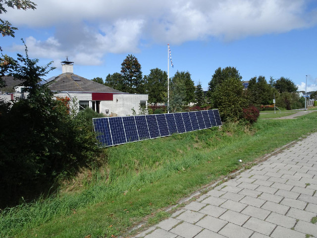 A garden wall made of solar panels.