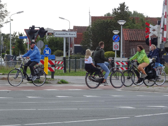 The bike heading to the right, with its typical Dutch passenger arrangement, has just come of the en...